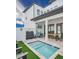 Backyard patio featuring pool, outdoor seating, and modern architecture, perfect for relaxation at 235 Villa Domani Cir, Davenport, FL 33896