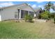 Spacious backyard features a screened lanai, lawn, garden, and mature trees at 236 Ridge View Dr, Davenport, FL 33837