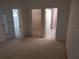 Bedroom with neutral carpet with views to a closet and bathroom at 236 Ridge View Dr, Davenport, FL 33837