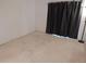 Empty bedroom with neutral carpet and window with dark curtains at 236 Ridge View Dr, Davenport, FL 33837