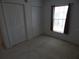 The carpeted bedroom has two closets and a window at 236 Ridge View Dr, Davenport, FL 33837