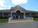 Community clubhouse with accessible entrance, professional landscaping, and plenty of parking at 236 Ridge View Dr, Davenport, FL 33837
