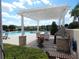 Relaxing pool area with grill, seating under a shaded pergola and lounge chairs at 236 Ridge View Dr, Davenport, FL 33837
