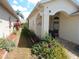 Charming front entrance with an arched doorway and beautiful landscaping at 236 Ridge View Dr, Davenport, FL 33837