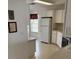 Cozy kitchen with ample cabinet space, a double door refrigerator, and tile flooring at 236 Ridge View Dr, Davenport, FL 33837