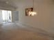Bright living room featuring a chandelier, neutral carpet, and slider to patio at 236 Ridge View Dr, Davenport, FL 33837