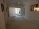 Spacious living room with slider access to screened porch and neutral carpet at 236 Ridge View Dr, Davenport, FL 33837