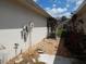 Functional side yard with gravel, utility connections, and minimal landscaping at 236 Ridge View Dr, Davenport, FL 33837