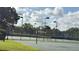 Community basketball court and tennis courts surrounded by lush landscaping and lighting for evening games at 239 Longhirst Loop, Ocoee, FL 34761