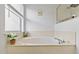 Bright bathroom featuring a soaking tub with a large window at 239 Longhirst Loop, Ocoee, FL 34761