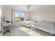 Bright bedroom featuring two beds, a ceiling fan, and large window views at 239 Longhirst Loop, Ocoee, FL 34761