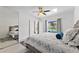 Bright bedroom features a ceiling fan, a view of the pool, and an en suite bathroom at 239 Longhirst Loop, Ocoee, FL 34761