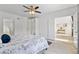Bright bedroom features a ceiling fan, carpeted floors, and an en suite bathroom at 239 Longhirst Loop, Ocoee, FL 34761