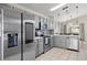 Modern kitchen features gray cabinets, stainless steel appliances, quartz countertops, and neutral backsplash at 239 Longhirst Loop, Ocoee, FL 34761