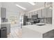 Modern kitchen with quartz countertops, stainless steel appliances, and plenty of natural light for culinary enjoyment at 239 Longhirst Loop, Ocoee, FL 34761
