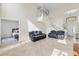 Spacious living room with plush leather seating and an open staircase leading to the upper level at 239 Longhirst Loop, Ocoee, FL 34761