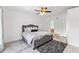 Comfortable bedroom featuring a ceiling fan and a view into the ensuite bathroom at 239 Longhirst Loop, Ocoee, FL 34761