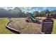 Community playground with slides and swings set in a natural setting at 239 Longhirst Loop, Ocoee, FL 34761