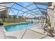 Relaxing screened pool area with hanging chair and lush backyard at 239 Longhirst Loop, Ocoee, FL 34761
