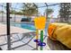 Poolside view with drinks and a towel offers an inviting scene for outdoor relaxation at 239 Longhirst Loop, Ocoee, FL 34761