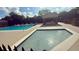 The community's large swimming pool and smaller pool with tables and chairs under a covered patio nearby at 239 Longhirst Loop, Ocoee, FL 34761