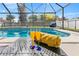 Beautiful pool area with covered lanai, pool, and lush landscaping perfect for relaxing and entertaining at 239 Longhirst Loop, Ocoee, FL 34761