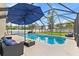 Inviting screened-in pool with comfortable lounge seating and umbrella at 239 Longhirst Loop, Ocoee, FL 34761