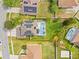 Aerial view of property lines, home with a pool and solar panels in a well-maintained, lush green neighborhood at 239 Longhirst Loop, Ocoee, FL 34761