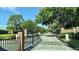 Gated community entrance with well-maintained landscaping at 239 Longhirst Loop, Ocoee, FL 34761