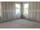Unfinished bedroom featuring newly installed drywall and bright, modern windows at 2395 Zuni Road, St Cloud, FL 34771