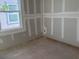 Unfinished bedroom featuring newly installed drywall and a bright, modern window at 2395 Zuni Road, St Cloud, FL 34771