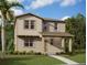 Charming two-story home with covered porch, manicured lawn and tropical landscaping at 2395 Zuni Road, St Cloud, FL 34771