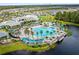 This aerial view features a community clubhouse, pool and a surrounding array of homes at 2457 Cliff Way, St Cloud, FL 34771