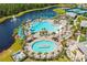 The aerial view showcases the community pool, and scenic lake with fountain feature at 2457 Cliff Way, St Cloud, FL 34771
