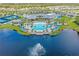 A scenic aerial view showcases the community clubhouse, pool, and surrounding landscape at 2457 Cliff Way, St Cloud, FL 34771