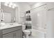 Well-lit bathroom featuring a shower over tub, and a gray vanity with solid surface counters at 2457 Cliff Way, St Cloud, FL 34771