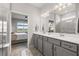 Elegant bathroom with double vanity, spacious shower, and view into the main bedroom at 2457 Cliff Way, St Cloud, FL 34771