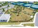 The aerial view showcases the fenced community dog park with shade trees and seating at 2457 Cliff Way, St Cloud, FL 34771