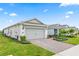 View of the home's side and front, featuring brick paver driveway leading up to a two-car garage at 2457 Cliff Way, St Cloud, FL 34771