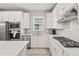 Modern kitchen with white cabinets, quartz countertops, and stainless steel appliances at 2457 Cliff Way, St Cloud, FL 34771