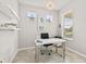 Bright office with white desk, modern lighting, and window view at 2457 Cliff Way, St Cloud, FL 34771