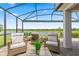 Spacious screened patio with cozy seating areas overlooking a picturesque lake at 2457 Cliff Way, St Cloud, FL 34771