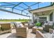 Inviting screened patio with ample seating, perfect for enjoying the peaceful lake view at 2457 Cliff Way, St Cloud, FL 34771