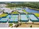This aerial view highlights the tennis courts and clubhouse in the community at 2457 Cliff Way, St Cloud, FL 34771