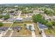 Aerial view of a turquoise home with palm trees, nestled within a residential neighborhood with lush landscaping at 2558 Academy Ave, Deltona, FL 32738