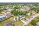 High-angle shot of a turquoise home surrounded by a residential area with mature trees and varied rooflines at 2558 Academy Ave, Deltona, FL 32738