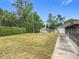Lush backyard featuring mature trees and privacy hedges, offering serene outdoor living space at 2558 Academy Ave, Deltona, FL 32738