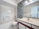 Bathroom with floral wallpaper, updated fixtures, and shower-tub combination at 2558 Academy Ave, Deltona, FL 32738