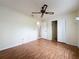 Spacious bedroom with a ceiling fan and closet with sliding doors, offering ample storage at 2558 Academy Ave, Deltona, FL 32738