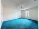Bedroom with white walls, ceiling fan, window with blinds, and blue carpet at 2558 Academy Ave, Deltona, FL 32738